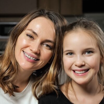 mom with braces and daughter smiling