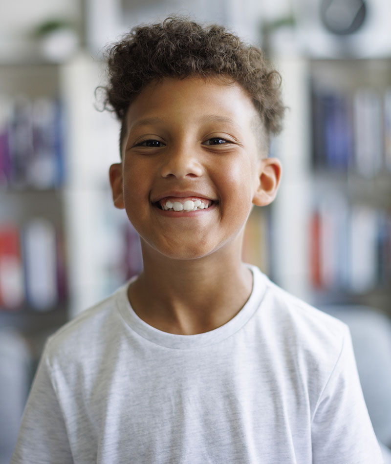 boy in white t-shirt smiling