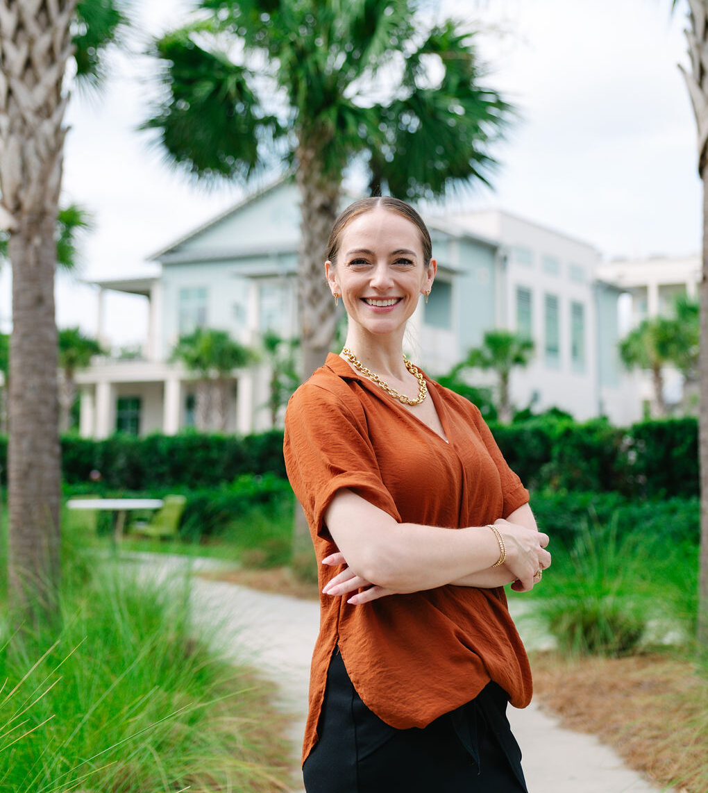 Adult woman with crossed arm smiling outdoors, Charleston, Bocklet Orthodontics