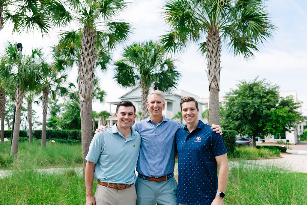 Drs. Bocklet, father-and-sons team in Charleston, smiling on the beach